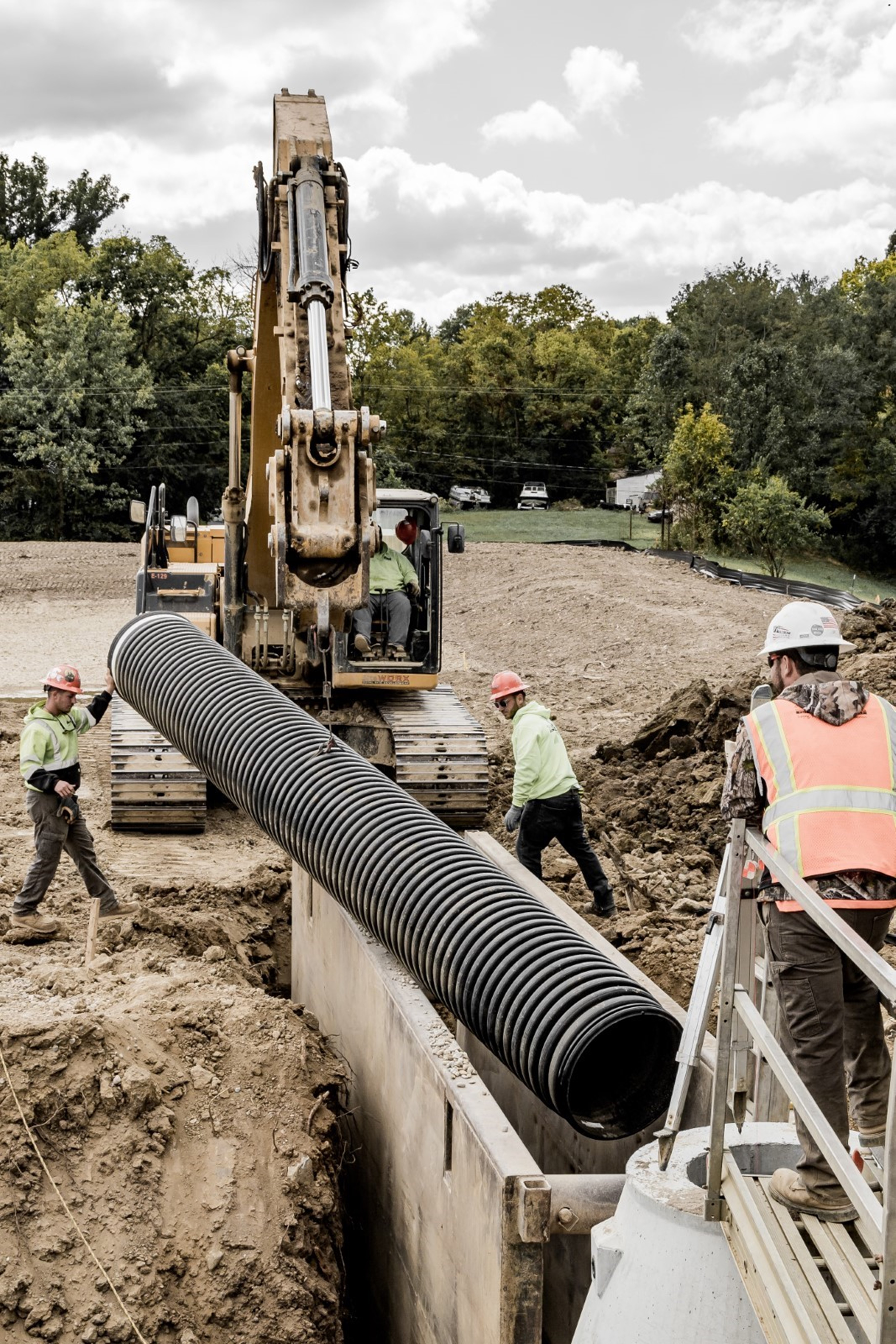 construction workers pipe laying